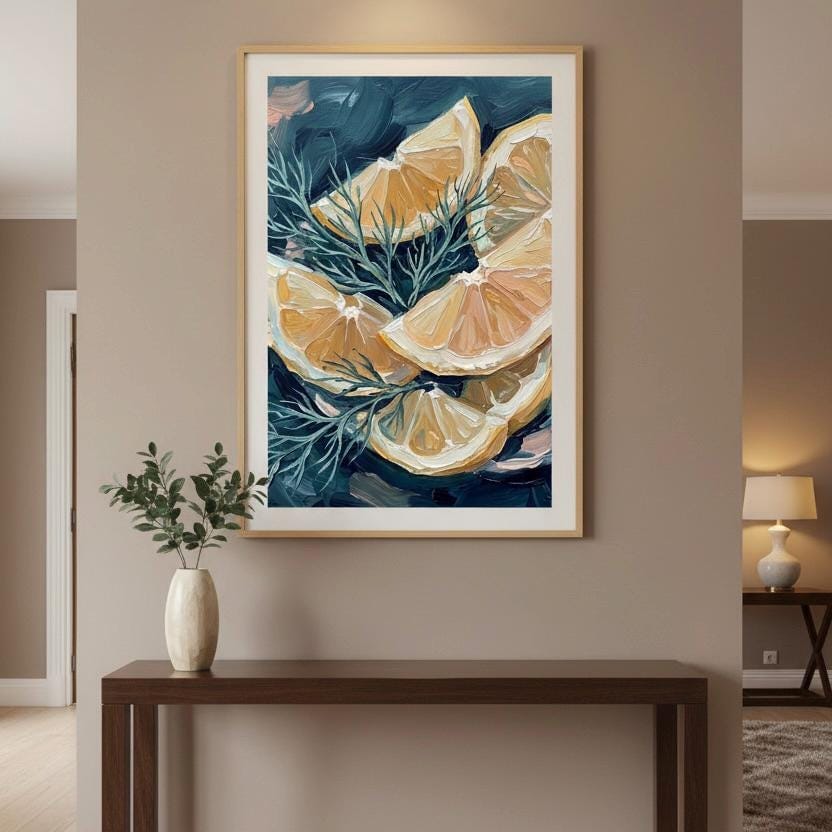 a framed painting of sliced oranges hanging on a wall above a wooden console table.