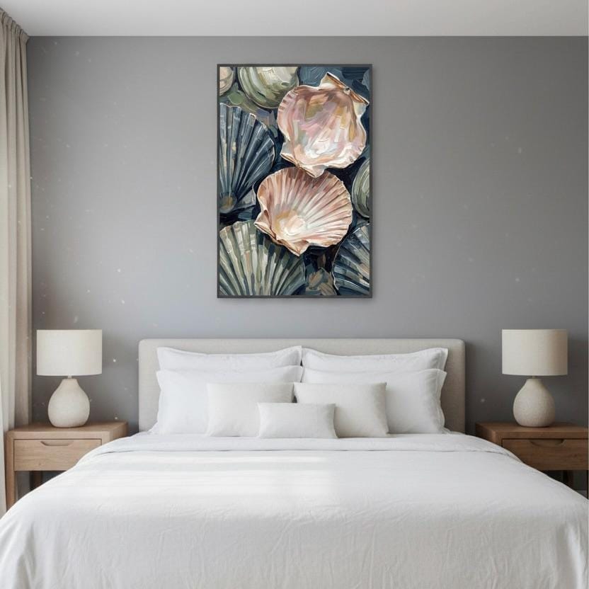 a bedroom with a large bed, white bedding, and two nightstands with lamps on either side. Above the bed is a framed artwork depicting a collection of seashells in various shades of pink and white.
