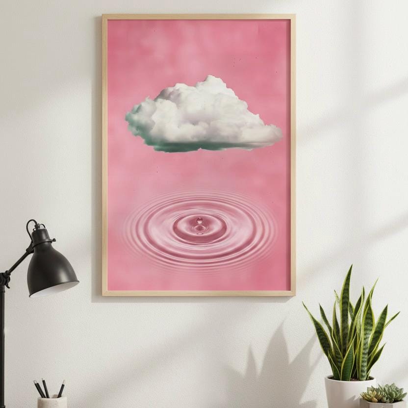 a framed poster of a cloud against a pink background, with a water droplet below it, creating a serene and calming atmosphere.