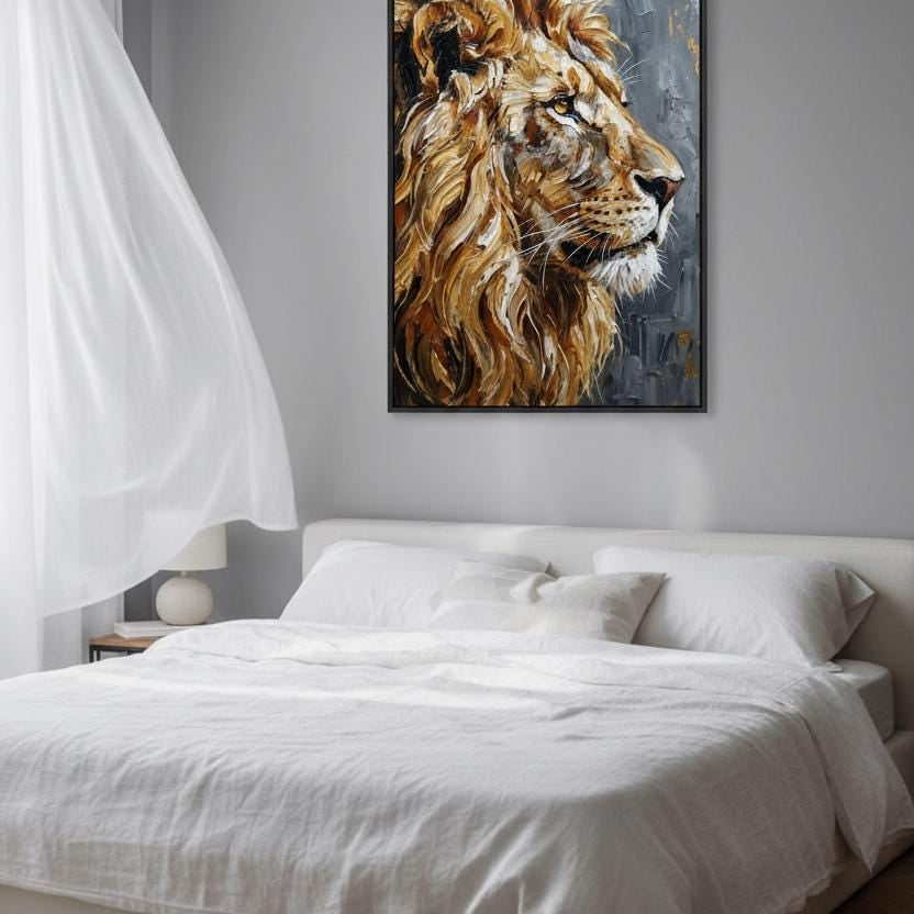 a large, white bed with a framed painting of a lion's head hanging above it. The painting is the focal point of the room, which also includes a window, a nightstand, and a vase on a side table.