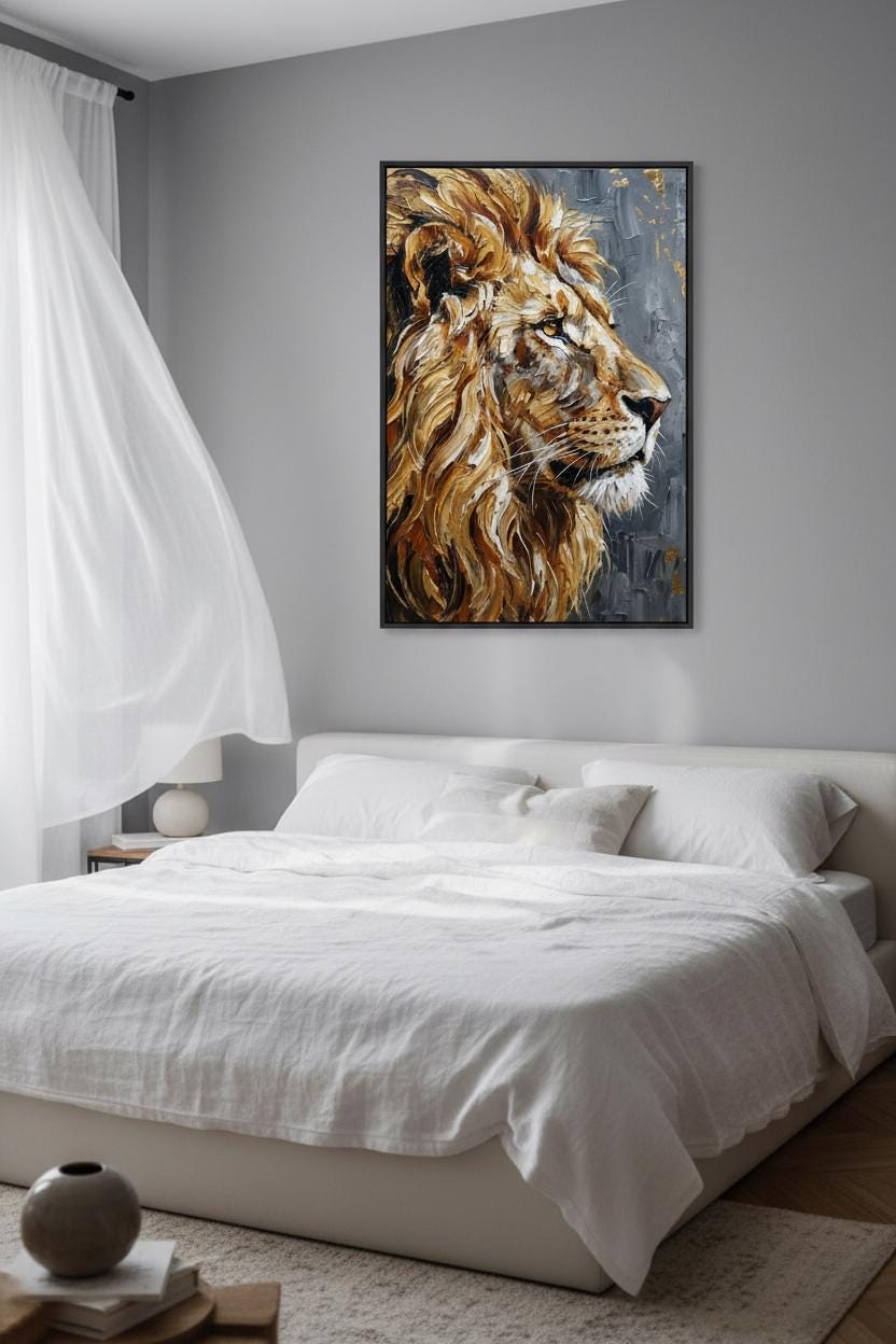 a large, white bed with a framed painting of a lion's head hanging above it. The painting is the focal point of the room, which also includes a window, a nightstand, and a vase on a side table.