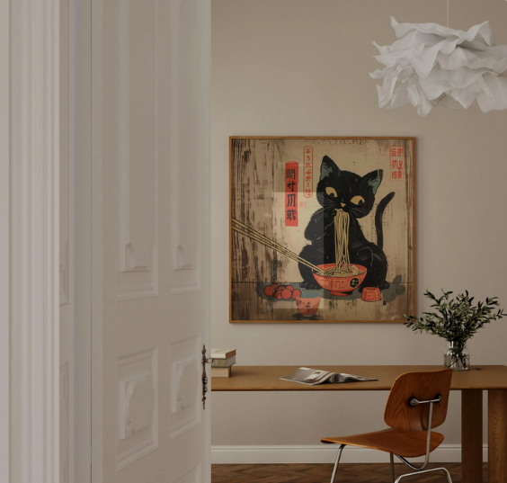 a black cat sitting in a bowl of noodles, with a framed artwork of the cat on the wall above a wooden desk.