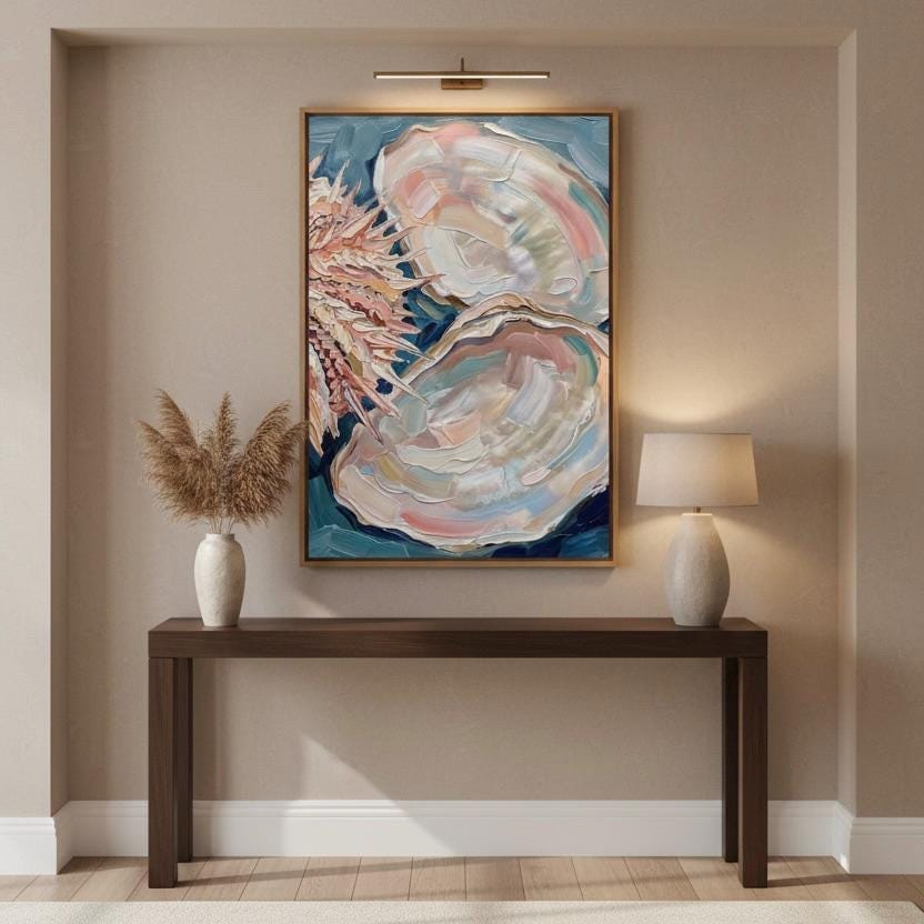 a large painting of an oyster shell hanging on a wall above a wooden console table with two lamps on either side.