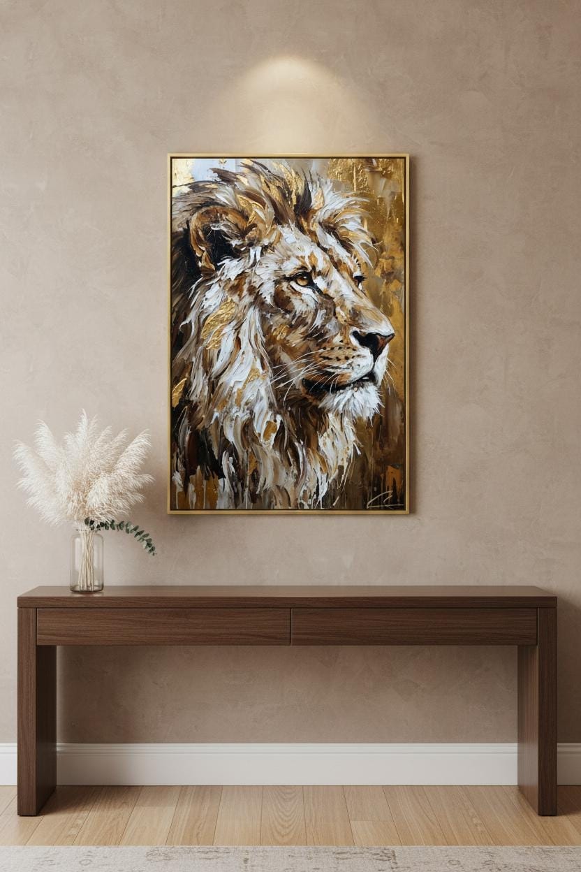 a large painting of a lion's head hanging on a wall above a wooden console table.