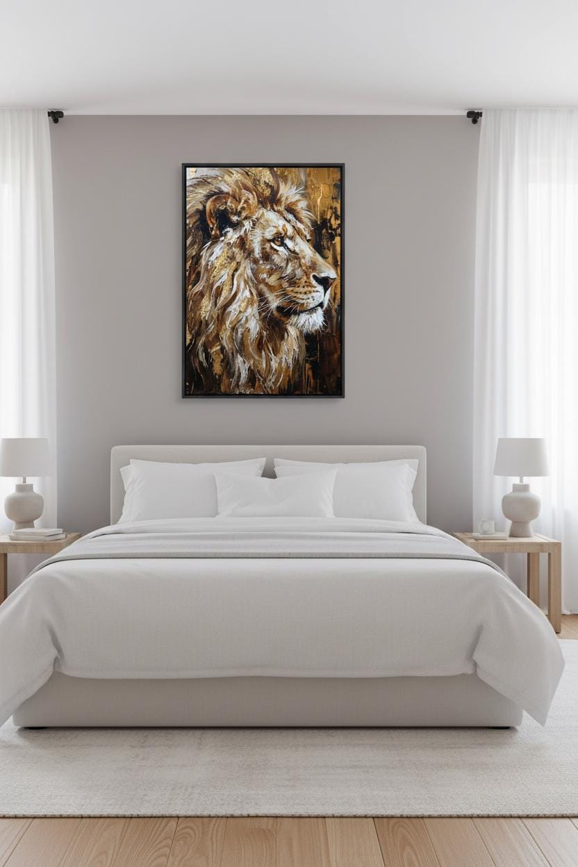 a large, white bed with a framed painting of a lion's head above it, creating a serene and elegant bedroom setting.